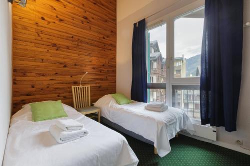 two beds in a room with a window at Chamonix Sud - Balme 302 - Happy Rentals in Chamonix-Mont-Blanc