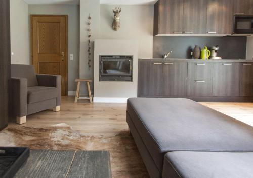 a living room with a bed and a couch and a tv at Appart Laijola in Gaschurn