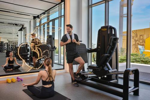 a man and a woman in a gym at The WB Abu Dhabi, Curio Collection By Hilton in Abu Dhabi