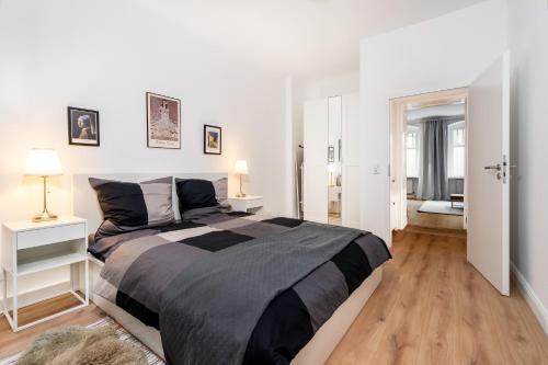 a bedroom with a large bed in a white room at 2-Room Apartment near Messe and Lietzensee in Berlin