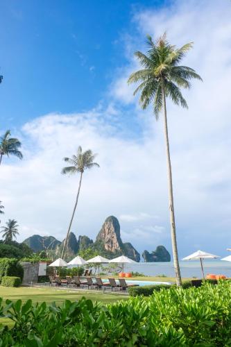 a view of the beach with palm trees and the ocean at Tinidee Hideaway Tonsai Beach Krabi - SHA Extra Plus in Tonsai Beach
