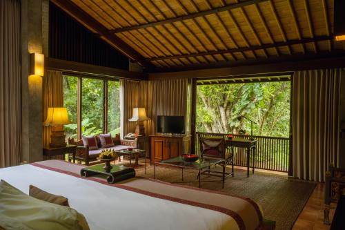 een slaapkamer met een groot bed en een balkon bij Dua Dari, a Residence by Hadiprana in Ubud