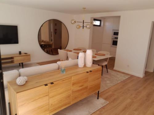 a living room with a couch and a mirror at Beachfront Apartment in Vila Praia de Âncora