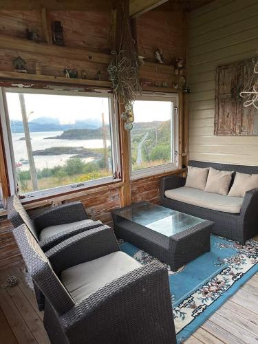 a living room with two couches and a coffee table at Bestefarhuset in Hakkstabben