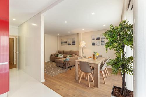 a living room with a table and a couch at Liberdade Home Stay - Minho's Guest in Braga