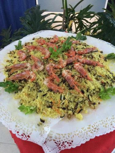 a plate of food with shrimp on top of rice at Bellevue del Golfo Hotel & Spa in Sferracavallo