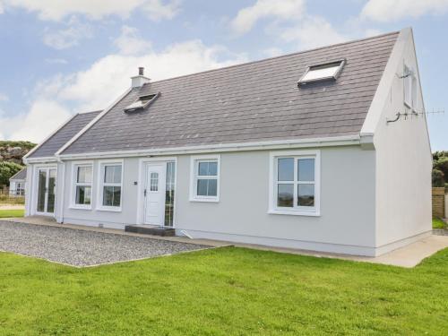 a white house with a grey roof at The Haven in Falcarragh