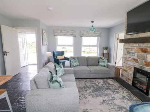 a living room with a couch and a fireplace at The Haven in Falcarragh