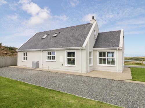 a white house with a grey roof at The Haven in Falcarragh