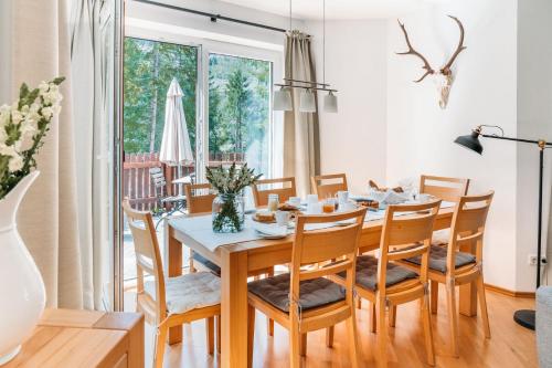 a dining room with a table and chairs at Ferienhaus Florianiweg in Bad Gastein