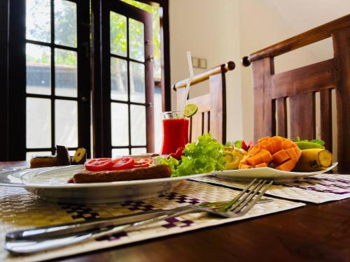 a plate of food on a table with a plate of food at Urban Galle Villa in Galle