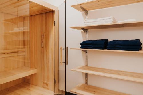 a walk in closet with wooden shelves and a glass door at Ferienhaus Florianiweg in Bad Gastein