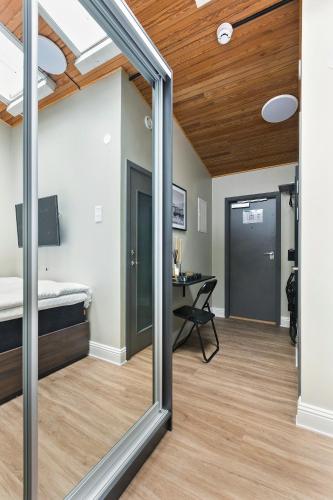 a mirror in a room with a bed and a desk at At Old Town Aparthotel in Stockholm