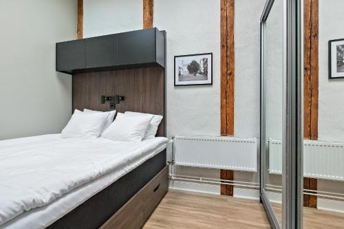 een slaapkamer met een bed met een zwart hoofdeinde bij At Old Town Aparthotel in Stockholm