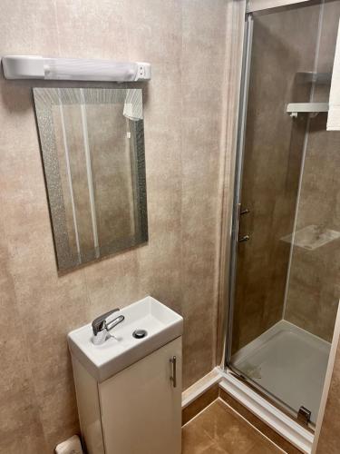 a bathroom with a shower and a toilet and a sink at The Oxfordshire in Blackpool