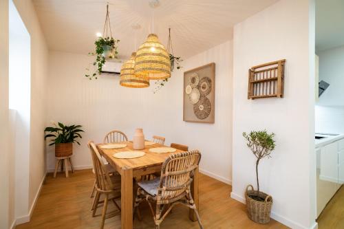 a dining room with a wooden table and chairs at Lookout Nazaré in Nazaré