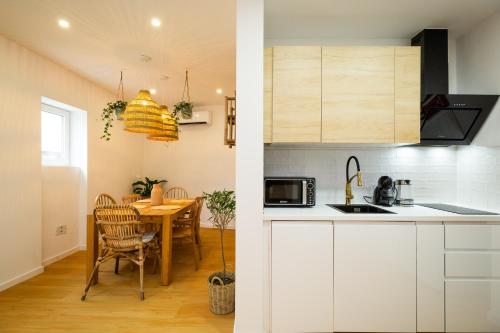 a kitchen and a dining room with a table at Lookout Nazaré in Nazaré