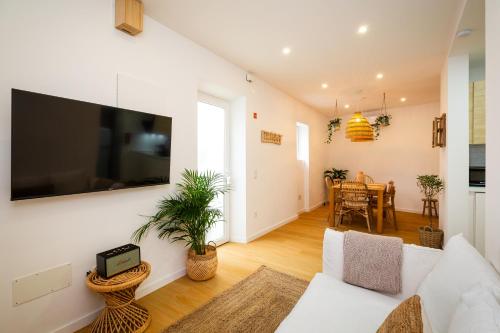 a living room with a large flat screen tv on a wall at Lookout Nazaré in Nazaré