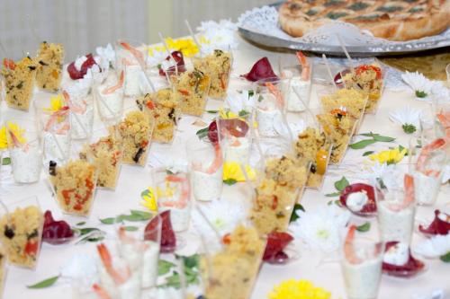 a table topped with lots of appetizers and snacks at Bellevue del Golfo Hotel & Spa in Sferracavallo
