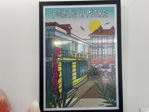 a framed picture of a city street with the words promote a future at PENTHOUSE 10 MIN port croisière et aéroport in Pointe-à-Pitre