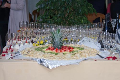 a table with wine glasses and a pineapple on it at Bellevue del Golfo Hotel & Spa in Sferracavallo