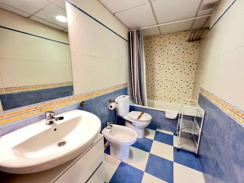 a bathroom with a sink and a toilet at PUSHE Playa Granada Beach & Golf 17 in Motril