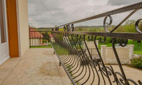 a balcony with a bench and a view of a yard at Le gite des deux familles in Chauffour-lès-Bailly