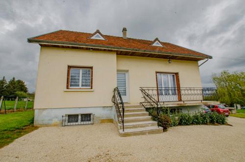 a small house with a staircase in front of it at Le gite des deux familles in Chauffour-lès-Bailly