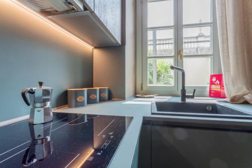 a kitchen with a robot on a counter next to a sink at Lagrange Design Apartments by Wonderful Italy in Turin