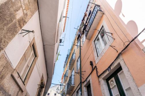 un callejón entre dos edificios en una ciudad en Apartamento vista rio Tejo em Alfama, TTL99, en Lisboa