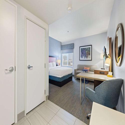 a hotel room with a bed and a desk at Hampton Inn & Suites Modesto - Salida in Modesto