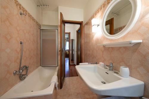 a bathroom with a sink and a shower and a tub at Asteria 29 skiing nearby - Happy Rentals in Bardonecchia