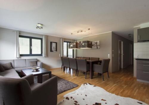 a living room and dining room with a couch and a table at Appart Laijola in Gaschurn