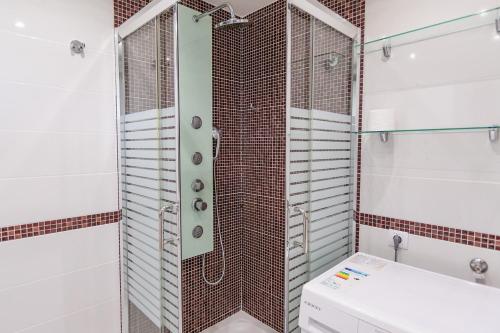 a shower with a glass door in a bathroom at Luxury studio in beachfront complex in El Duque area, Costa Adeje in Adeje