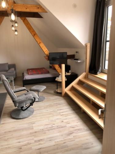 a room with a loft with a bed and a desk at Apartment am Stettiner Haff in Mönkebude
