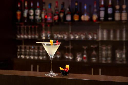 a martini glass sitting on top of a bar at Best Western Plus Thionville Centre in Thionville