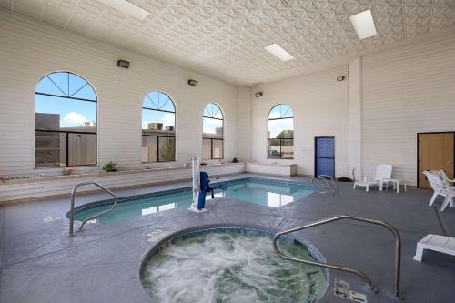 a swimming pool with a hot tub in a building at Quality Inn & Suites in Junction