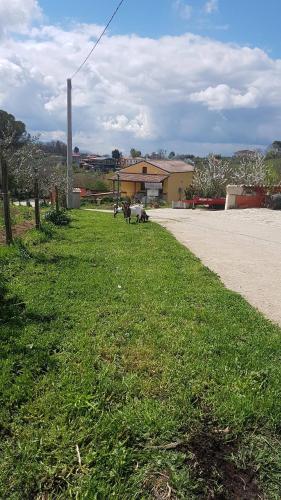 a field of green grass next to a road at Agriturismo San Tommaso in Ariano Irpino