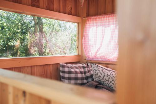 a room with a couch and a window in a room at Naturhotel Bauernhofer in Heilbrunn