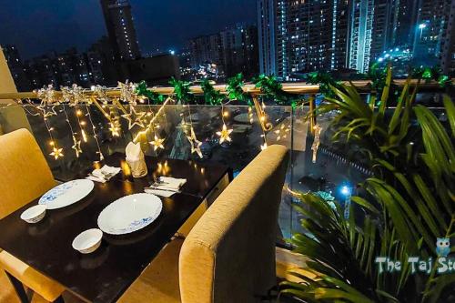 - Balcón con mesa de comedor y vistas a la ciudad en Best Cozy Stay in Central Noida , Mall, Free WiFi, Parking, Private Apartment - The Taj Studios, en Noida