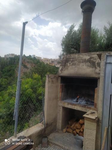 an outdoor oven with a stack of food in it at Casa Chorreón in Letur