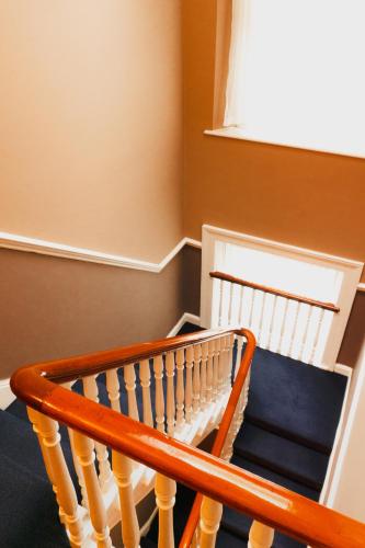 a wooden stair railing in a room with a window at Phoenix Park Hotel in Dublin