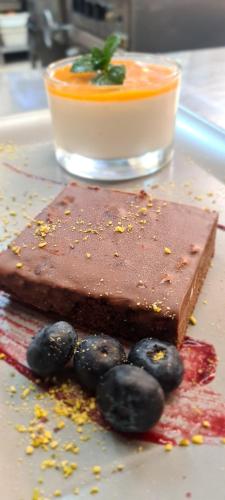 a chocolate dessert on a plate with black olives at Hotel & Restaurant Zum Deutschen Hause in Kirchhatten