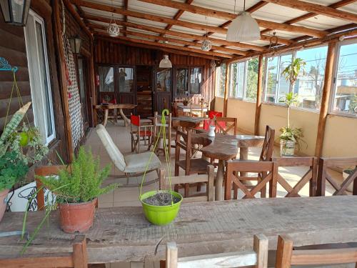 a restaurant with wooden tables and chairs and windows at hosteria Don López in Colón