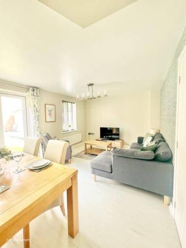 a living room with a couch and a table at Modern 3 bed home, Chesterfield in Chesterfield