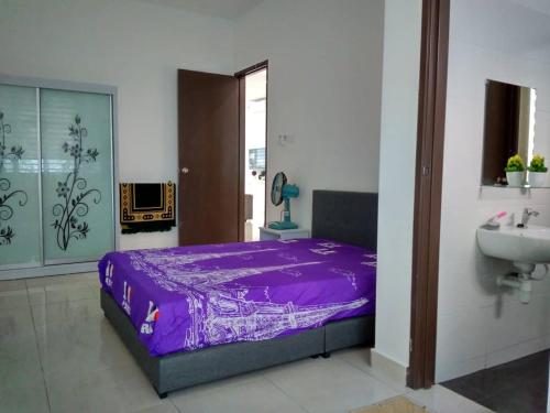 1 dormitorio con cama morada y lavamanos en HOMESTAY BATU PAHATKU- HOMESTAY IMAN en Batu Pahat