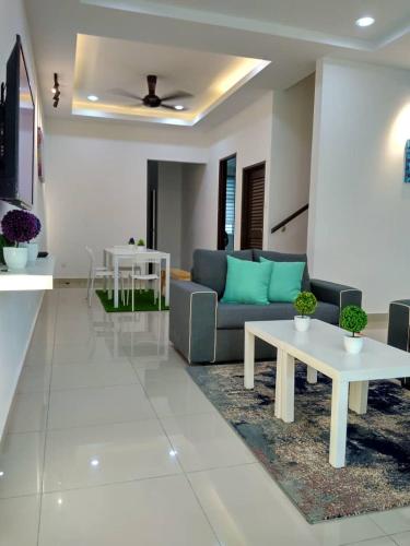 a living room with a couch and a table at HOMESTAY BATU PAHATKU- HOMESTAY IMAN in Batu Pahat