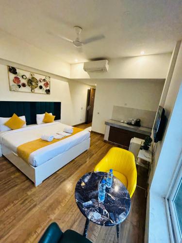 a hotel room with a bed and a table and chairs at Amahi Inn I Signature Towers in Gurgaon
