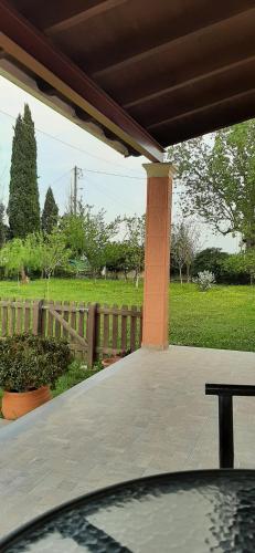 a patio with a fence and a table and a field at Lonelia's Family Homes in Lefkímmi