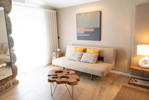 a living room with a couch and a table at Quinta de Silvalde in Santo Tirso